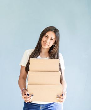 Zero waste, plastic free. Craft boxes in woman hands. Beautiful smiling woman holding blank boxes. Mock up design