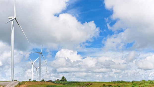 Beautiful nature landscape windmills field on the hill and blue sky, white clouds are the background at Khao Kho, Phetchabun Province, Thailand, 16:9 wide screen
