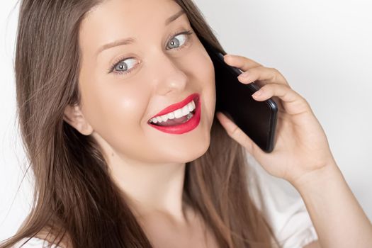 Happy smiling woman calling on smartphone, portrait on white background. People, technology and communication concept.