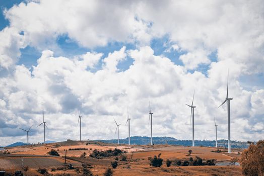 Vintage brown blue two tone style, beautiful nature landscape windmills field on the hill with sky and clouds background at Khao Kho, Phetchabun, Thailand