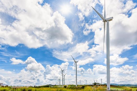 Beautiful landscape many windmills under the sun on blue sky and clouds background, Clean energy that is environmentally friendly at Khao Kho, Phetchabun, Thailand