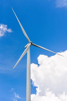 Beautiful wind turbine on blue sky and white clouds background, Eco-friendly electric power source Help reduce global warming