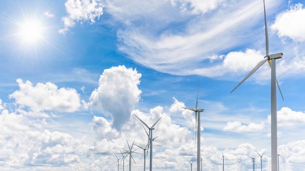 Beautiful many windmills under the sun on blue sky and white clouds background, Clean energy that is environmentally friendly electric power help reduce global warming