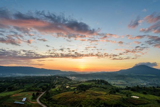 Beautiful nature landscape of the colorful sky and mountains during the sunrise at Khao Takhian Ngo View Point, Khao Kho attractions in Phetchabun, Thailand