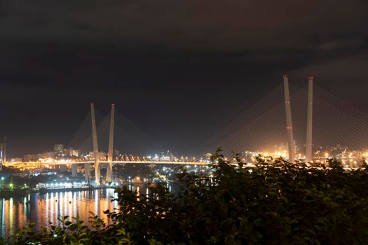 Night city landscape with a view of the Golden Bridge. Vladivostok, Russia