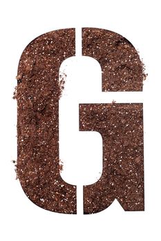 stencil letter G made above dirt on white surface