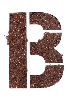 stencil letter B made above dirt on white surface