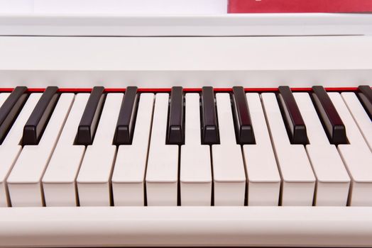Close-up of an electronic piano keyboard. white digital piano for playing classical or modern music.