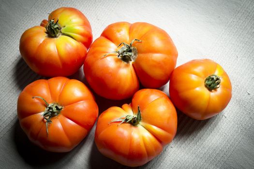 Group of uncooked raw red tomatoes. Raw food