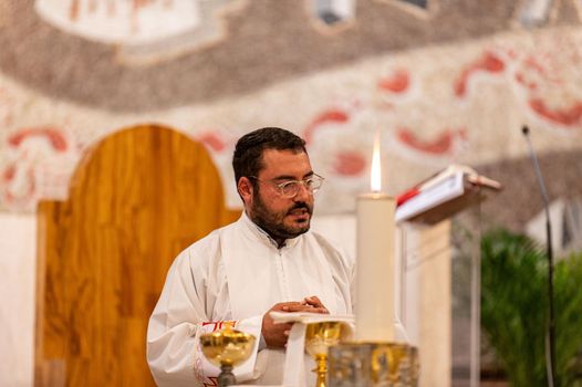 terni,italy may 21 2021:priests during the holy mass in the church of sacro cuore terni