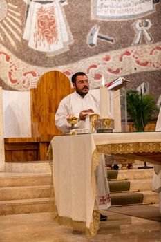 terni,italy may 21 2021:priests during the holy mass in the church of sacro cuore terni