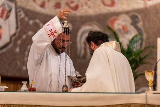 terni,italy may 21 2021:priests during the holy mass in the church of sacro cuore terni