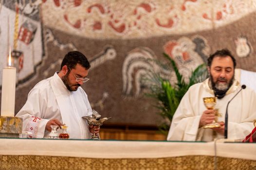 terni,italy may 21 2021:priests during the holy mass in the church of sacro cuore terni