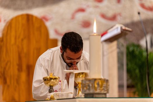 terni,italy may 21 2021:priests during the holy mass in the church of sacro cuore terni