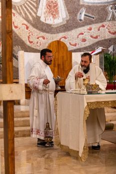 terni,italy may 21 2021:priests during the holy mass in the church of sacro cuore terni