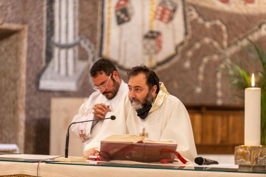 terni,italy may 21 2021:priests during the holy mass in the church of sacro cuore terni