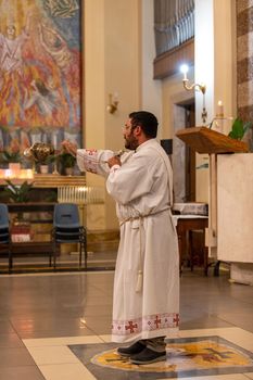 terni,italy may 21 2021:priests during the holy mass in the church of sacro cuore terni