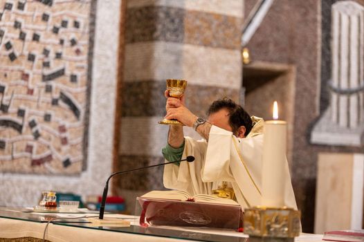 terni,italy may 21 2021:priests during the holy mass in the church of sacro cuore terni