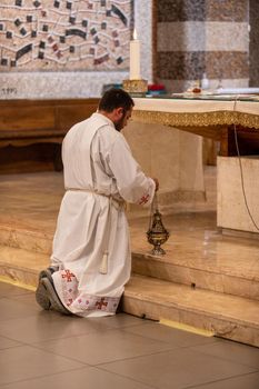 terni,italy may 21 2021:priests during the holy mass in the church of sacro cuore terni