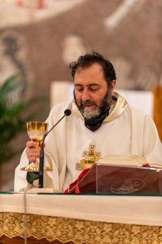 terni,italy may 21 2021:priests during the holy mass in the church of sacro cuore terni