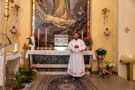 terni,italy may 21 2021:priests during the holy mass in the church of sacro cuore terni