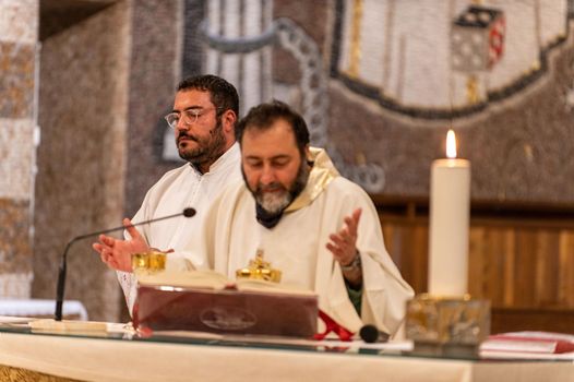 terni,italy may 21 2021:priests during the holy mass in the church of sacro cuore terni