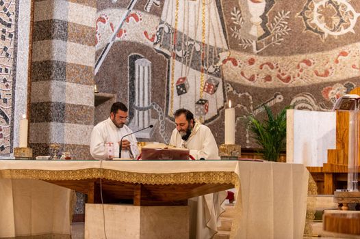 terni,italy may 21 2021:priests during the holy mass in the church of sacro cuore terni