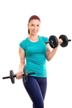 Fit attractive young smiling woman in sportswear doing dumbbell concentration curls, isolated on white background. Fitness and healthy lifestyle concept. Young woman exercising with dumbbells.