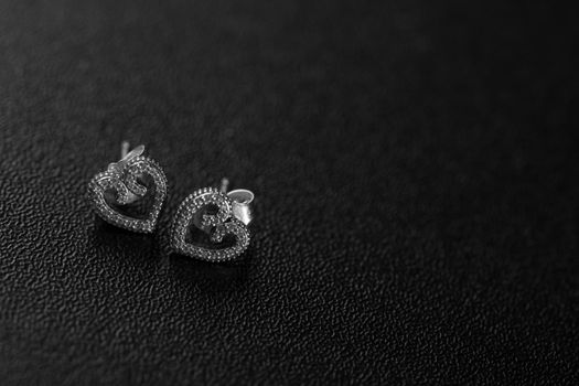 Beautiful silver earrings isolated on black, close up