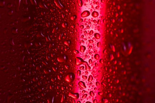 Water droplets on red metallic can