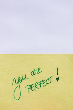 You are perfect handwriting text close up isolated on yellow paper with copy space.
