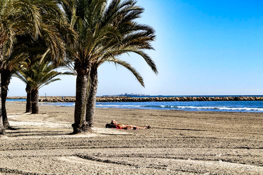 Sunny day on the beach in winter in Santa Pola, Alicante