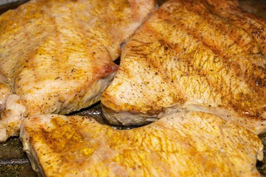 meat pieces fried in a grill pan close up. High quality photo