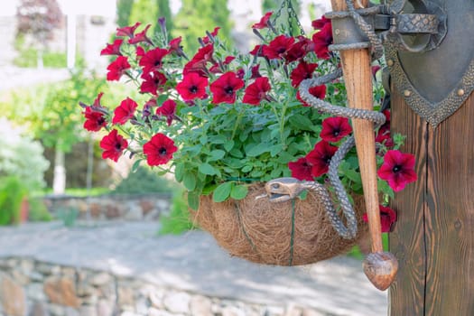 bronze snake on a pole on a background of red flowers. High quality photo