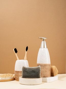 Natural organic selfcare products. Handmade soap, wooden brush and bamboo toothbrushes. Spa accessories creative art composition on beige background