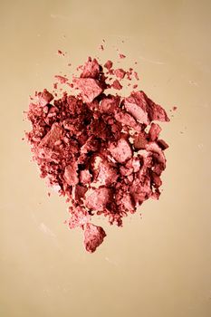 Crushed cosmetics, mineral organic eyeshadow, blush and cosmetic powder isolated on golden background, makeup and beauty banner, flatlay design.