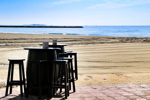 Bar with empty terrace on Santa Pola beach on a sunny day
