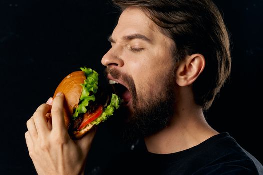 Man eating hamburger fast food restaurant diet and lifestyle