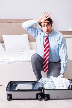 Young handsome businessman preparing for trip
