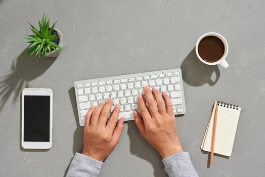 Man play with notebook Modern office desk with laptop and other supplies with cup of coffee for input the text on copy space Top view, flat lay.