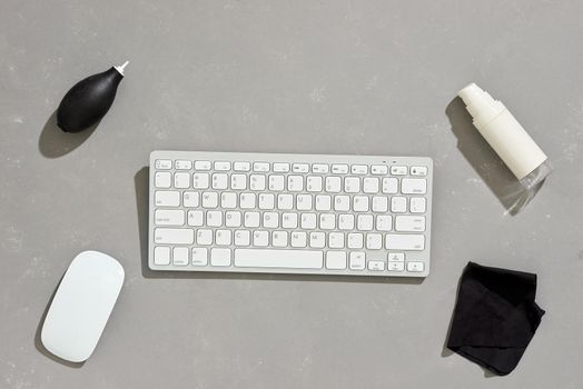 Liquid and cloth for cleaning equipment near a keyboard and mouse .