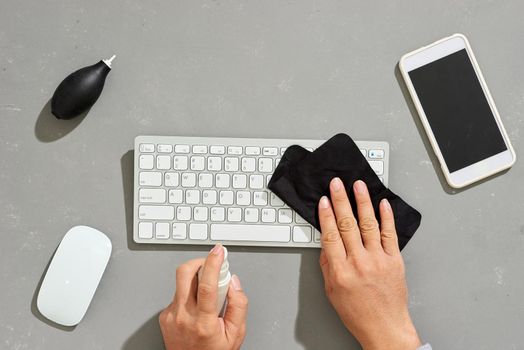 Cleaning the surface of keyboard computer with a black rag microfiber