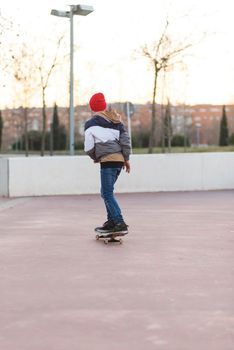 Teenager skateboarder boy with a skateboard on asphalt playground doing tricks. Youth generation Free time spending concept image.