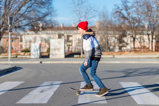 Teenager skateboarder boy with a skateboard on asphalt playground doing tricks. Youth generation Free time spending concept image.