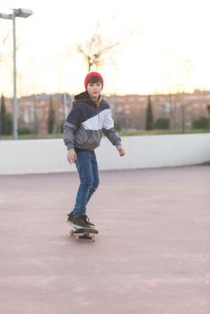 Teenager skateboarder boy with a skateboard on asphalt playground doing tricks. Youth generation Free time spending concept image.