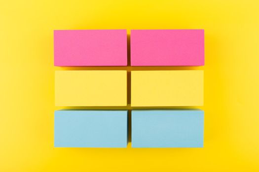 Pansexual flag made of pink, yellow and blue blocks on yellow background. Concept of pansexual community, sexual minorities and tolerance