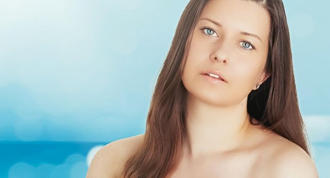 Skincare and sun protection in summer. Portrait of a beautiful young suntanned woman, blue sea and sky on background, beauty, wellness and travel concept.