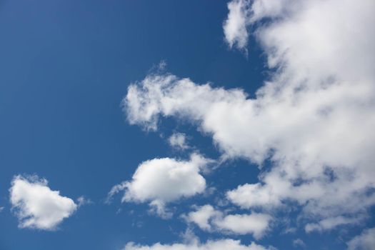 Beautiful sky background. Oddly shaped clouds in a blue sky.