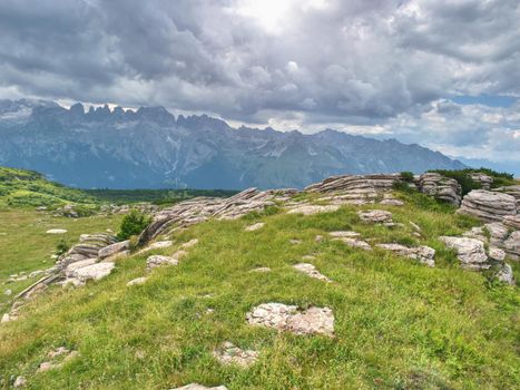 Beutiful summer Alps mountains, clouds above peaks and forest in foreground,