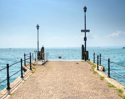 Veiw to the Garda lake from pier, summer holiday in Italy. 